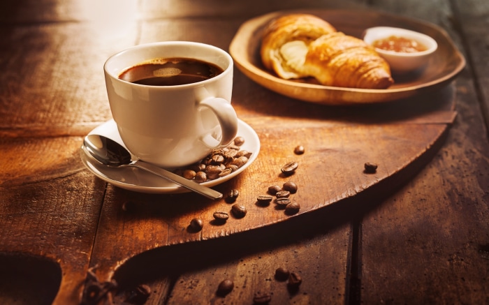 Coffee and croissants on a wooden table