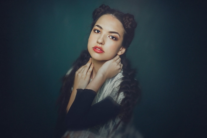 Young woman with braided buns and red lipstick