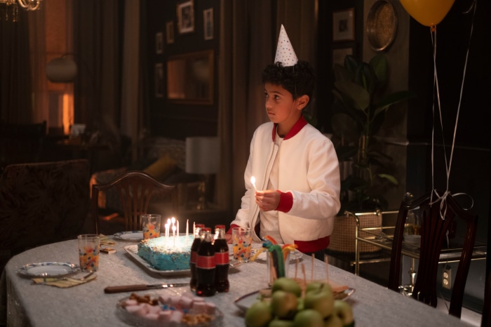 Boy with birthday cake and balloons