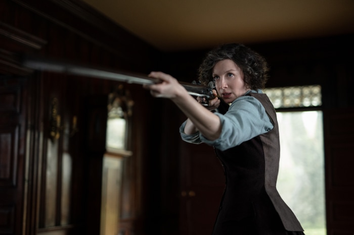 Claire Fraser from Outlander with a rifle