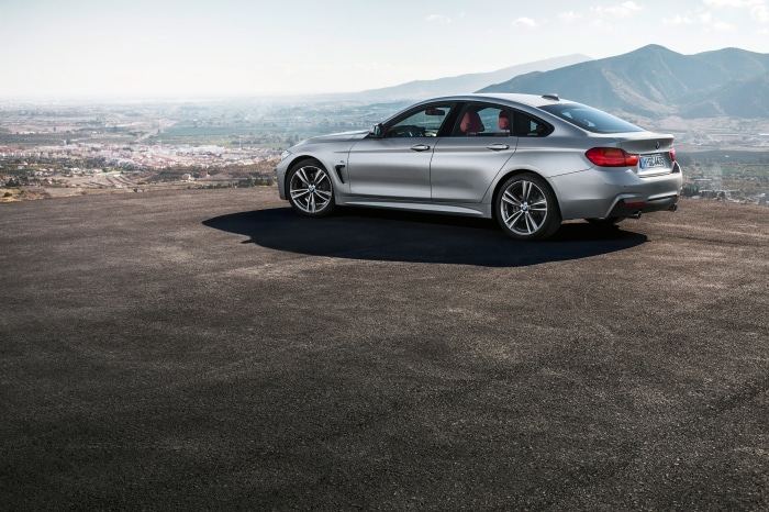 Silver BMW 4 Series Gran Coupé on a scenic overlook