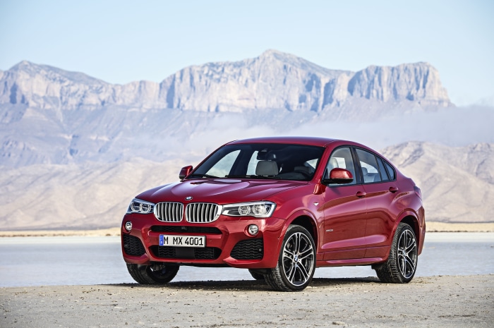 Red BMW X4 xDrive35i parked in a desert landscape