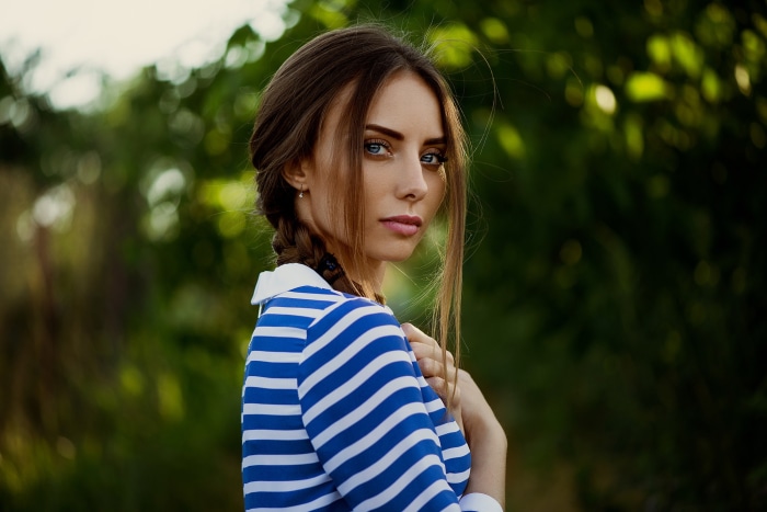Woman with braided hair wearing a striped shirt