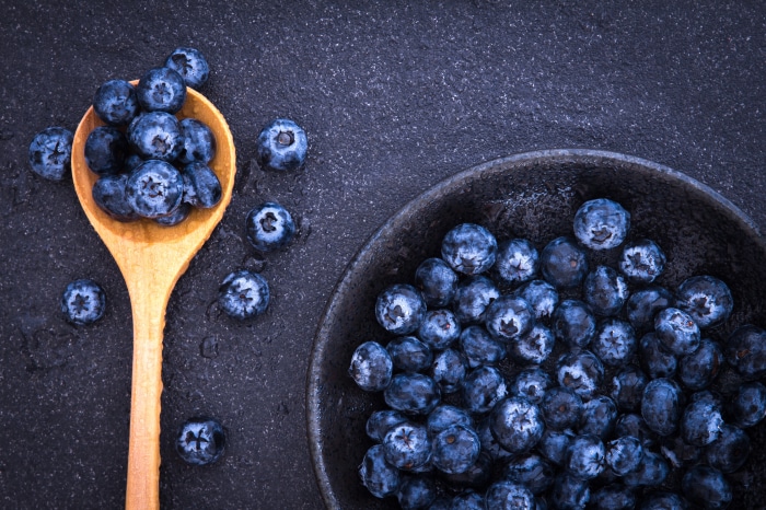 Blueberries in a wooden spoon and bowl 4K