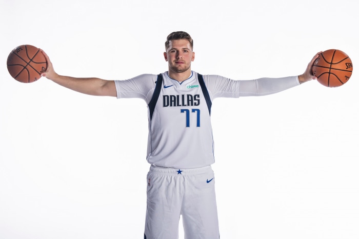 Luka Dončić holding two basketballs