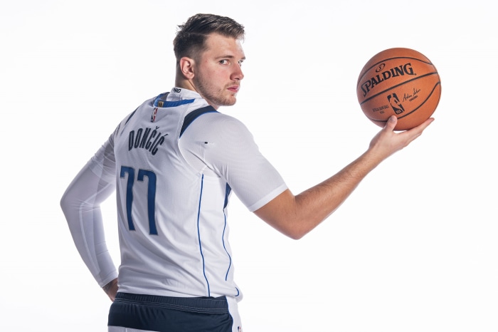 Luka Dončić holding a Spalding basketball