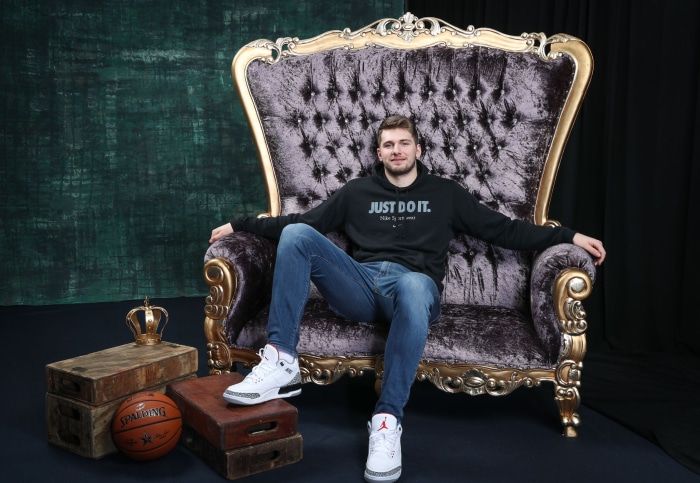 Luka Dončić sitting on a throne with basketball