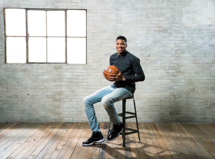 Giannis Antetokounmpo holding a basketball