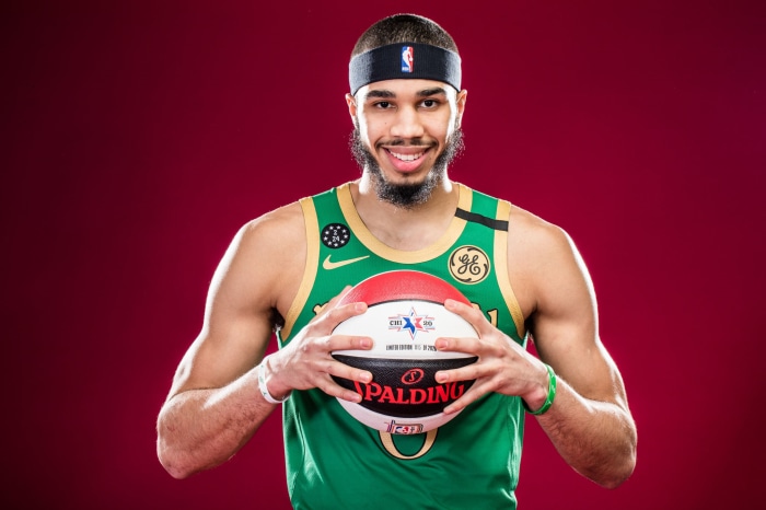 Jayson Tatum holding a Spalding basketball