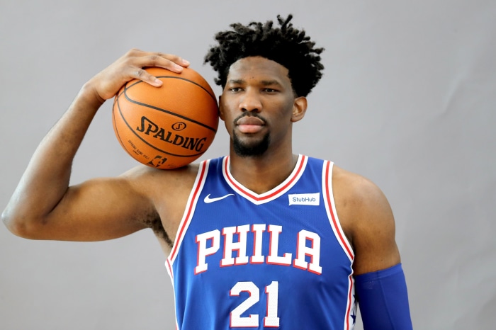 Joel Embiid of the Philadelphia 76ers holding a Spalding basketball