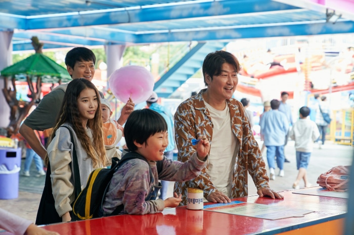 Family at an amusement park with cotton candy