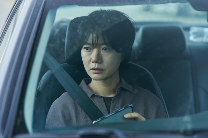 Woman in car holding phone
