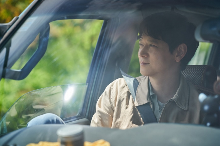 Man in a car looking out the window