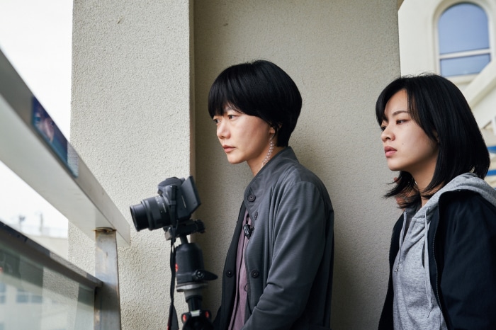 Two women and a camera on a tripod