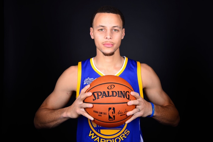 Stephen Curry from Golden State Warriors holding Spalding basketball