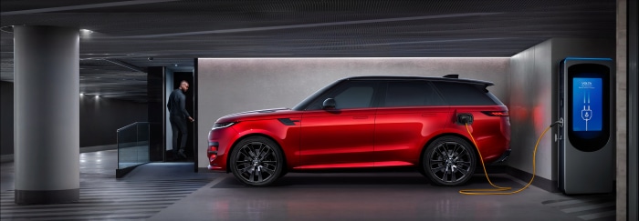Red Range Rover Sport PHEV charging in garage