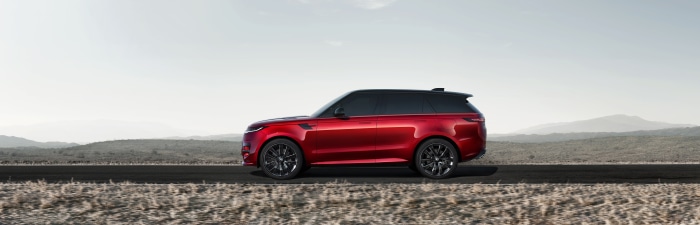 Red Range Rover Sport driving on a road