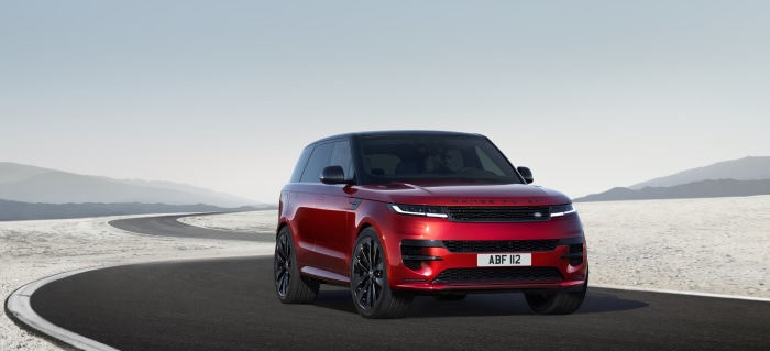 Red Range Rover Sport PHEV on a Winding Road