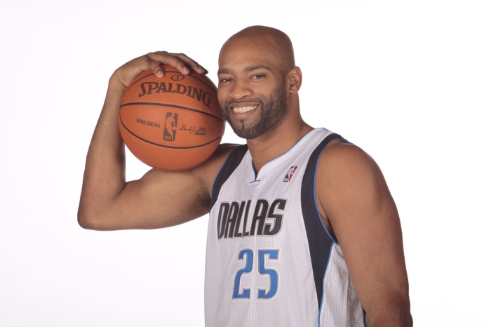 Vince Carter holding a Spalding basketball