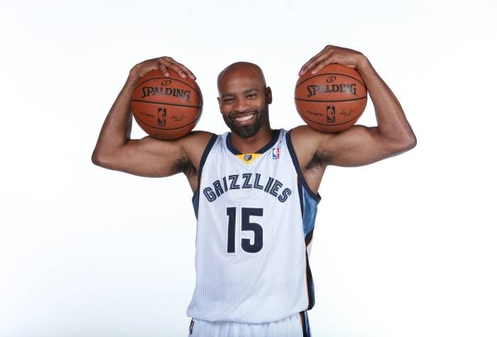 Vince Carter of the Memphis Grizzlies holding two basketballs