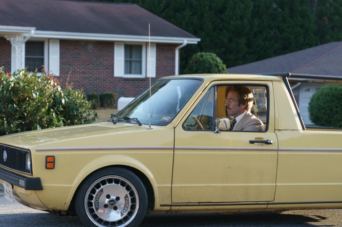 Timothy Simons driving a yellow pickup truck