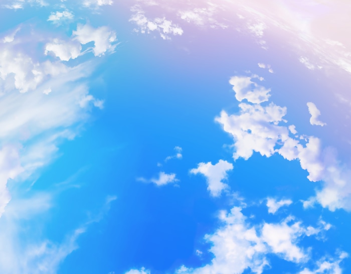 Blue sky with clouds and pinkish hue