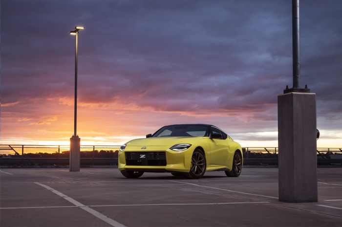 Yellow Nissan Z car in parking lot at sunset