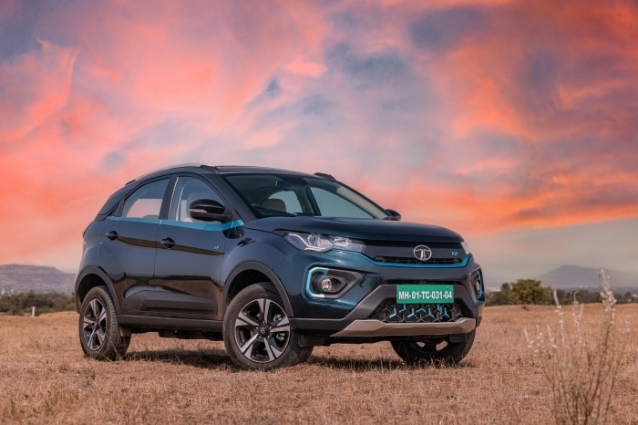 Tata Nexon electric car in a field at sunset