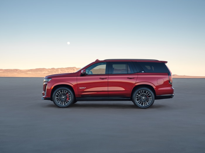 Red Cadillac Escalade V-Series SUV in desert landscape