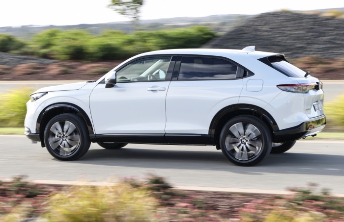 White Honda HR-V driving on a road
