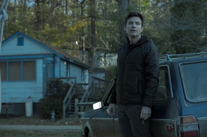 Marty Byrde from Ozark standing by a car
