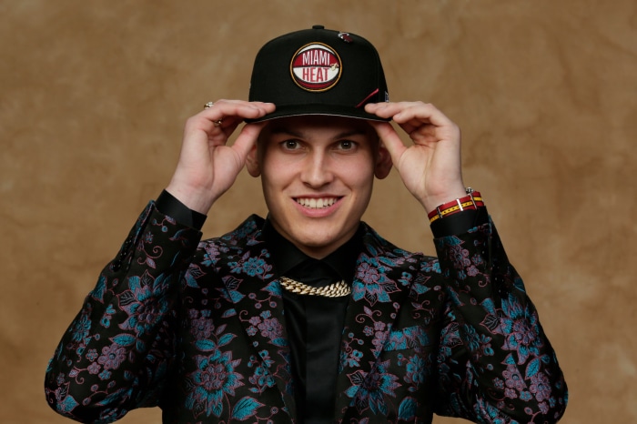 Tyler Herro wearing Miami Heat hat and suit