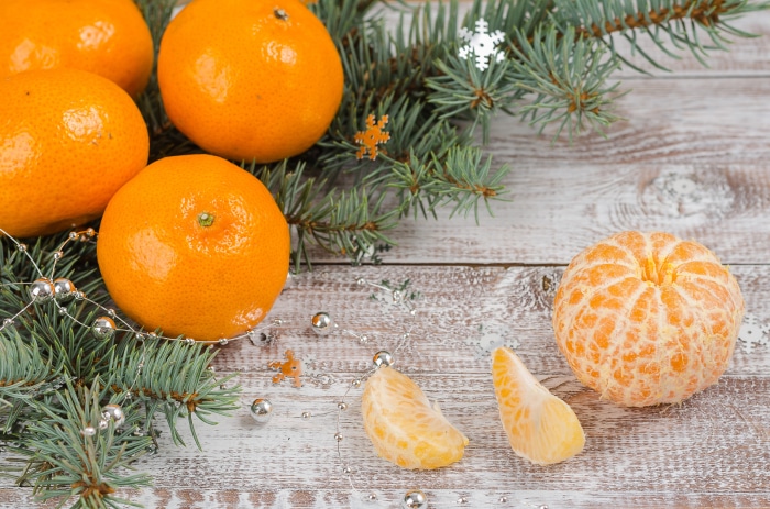 Mandarin oranges with pine branches and Christmas decorations