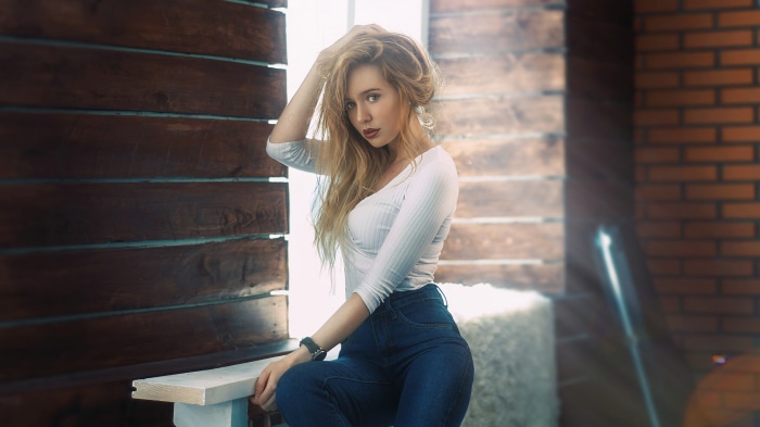 Young Woman with Blonde Hair in Jeans