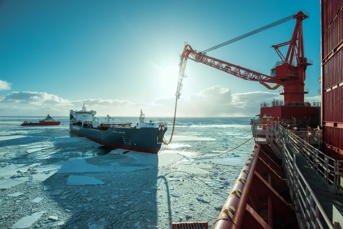 Oil tanker being filled at an offshore platform in icy waters