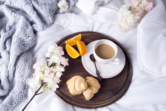 Breakfast in bed with coffee and croissants