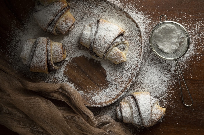Chocolate croissants dusted with powdered sugar