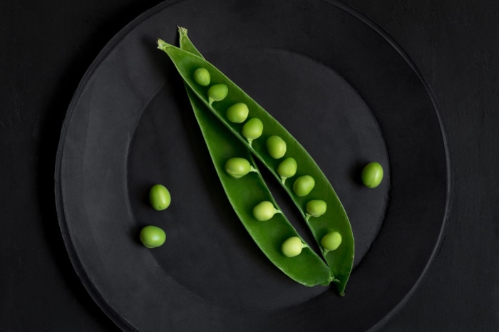 Peas on a black plate