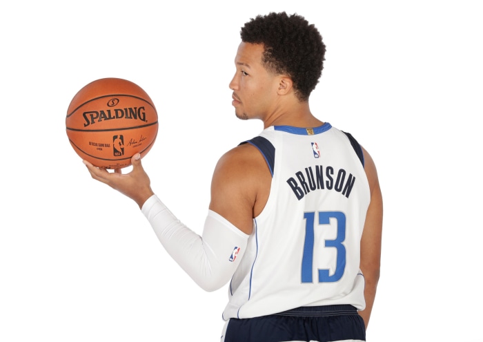 Jalen Brunson of the Dallas Mavericks holding a Spalding basketball