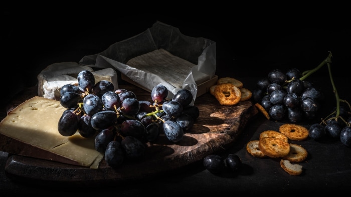 Still life with cheese, grapes, and crackers