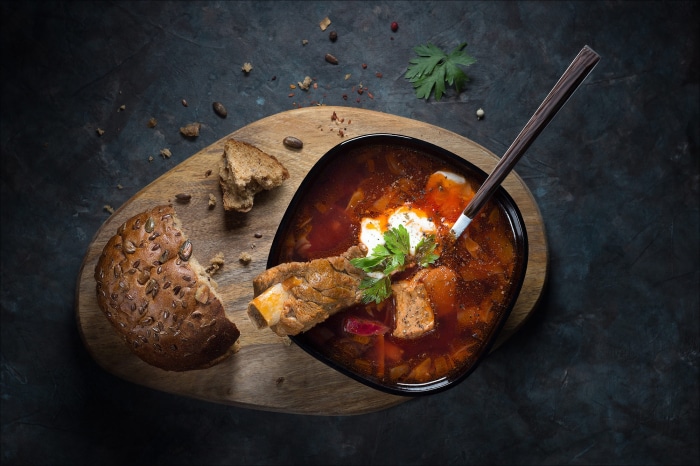 Bowl of borscht with meat and bread