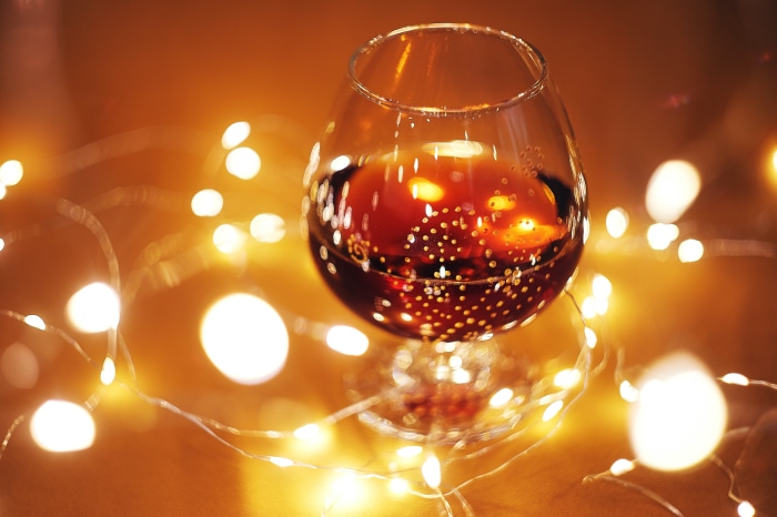 Alcohol in a glass with bokeh lights