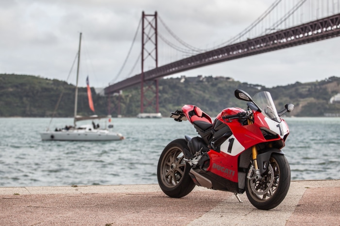 Red Ducati Panigale V4 motorcycle by a bridge