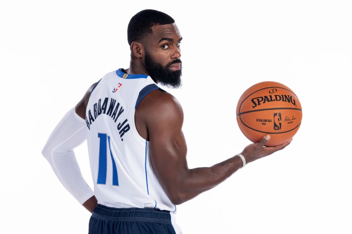 Tim Hardaway Jr. holding a Spalding NBA basketball