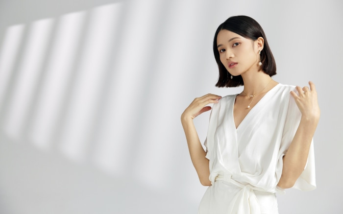 Asian Woman in White Dress with Pearl Jewelry