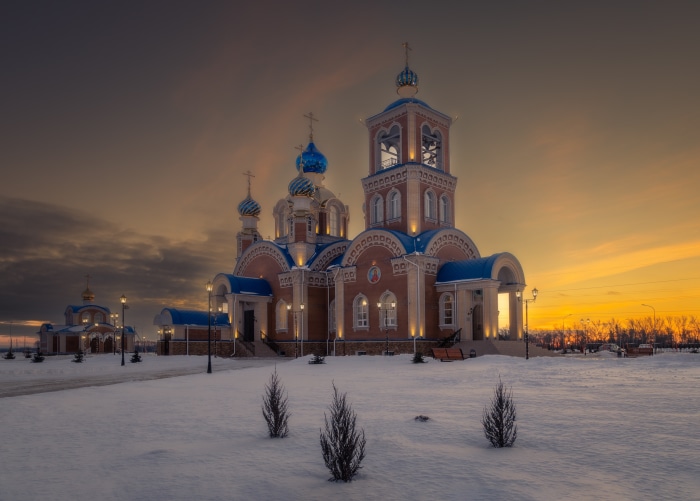 Orthodox Church with Blue Domes in Winter Sunset