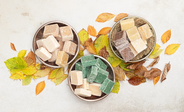 Assortment of candies in bowls with autumn leaves