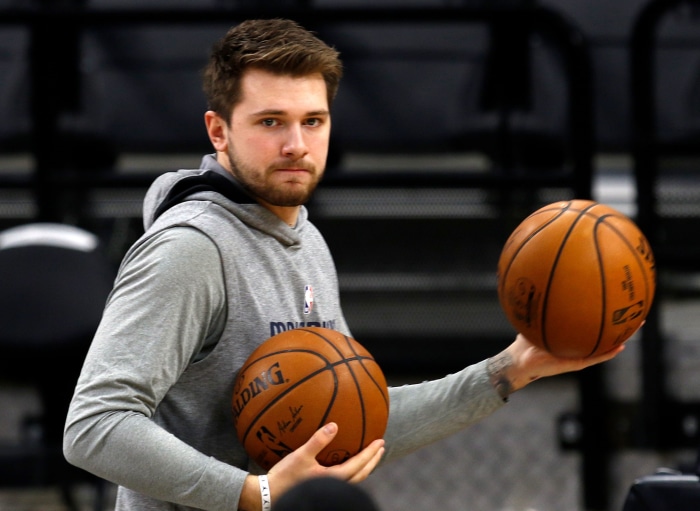 Luka Dončić holding basketballs