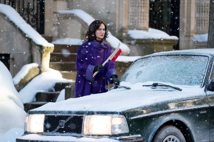 Woman from The Time Traveler's Wife clearing snow from car