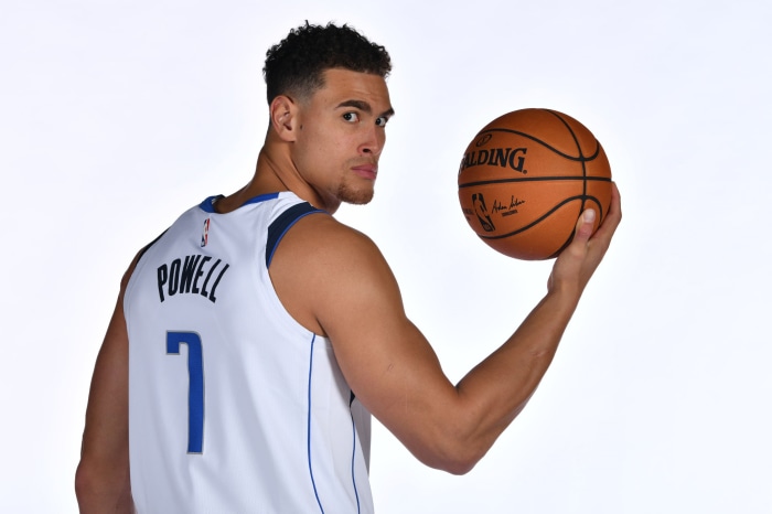 Dwight Powell of the Dallas Mavericks holding a Spalding basketball